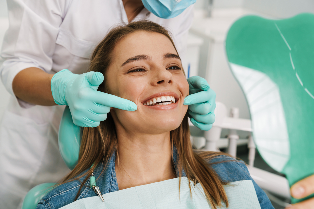 woman patient showing off smile at dentist